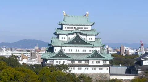 Elevated view of Nagoya Castle in clear, blue skies, and birds flying by Stock Footage 61482207
