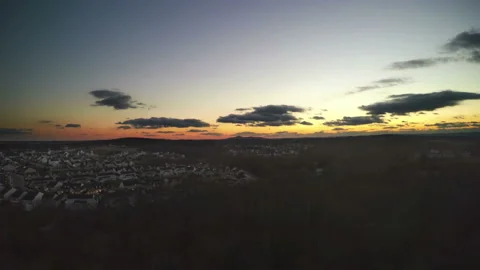 Elevated view of an orange sunset over a rural housing estate Stock Footage 153833292