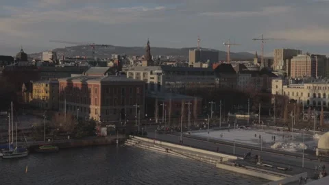 Elevated view of Oslo city skyline from Opera House roof with ice skating rink Stock Footage 340183438