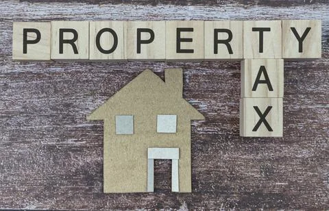 Elevated View Of Paper House Model Near Wooden Blocks With Property Tax Text Stock Photos