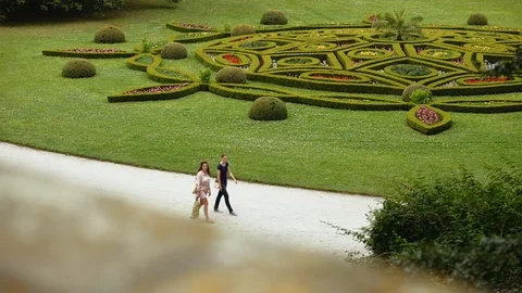 Elevated view of people walking next to ornamental garden of Archbishop Chateau. Video stock 113758978