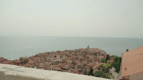 Elevated View of Piran Town and Red Roofs Framed Through Stone Stock Footage 341461840