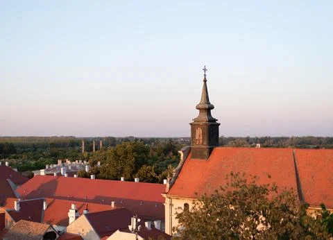 Elevated view of red-roofed buildings and a church spire Stock Photos