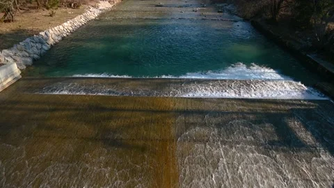 Elevated view of river flowing over wooden spillway Stock Footage 150444032