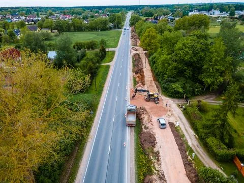 Elevated View of Road Construction Site with Excavator and Vehicles Stock Photos