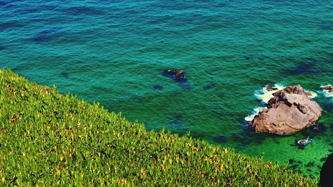 Elevated view of rocks in blue water sea and waves Stock Footage 93499514