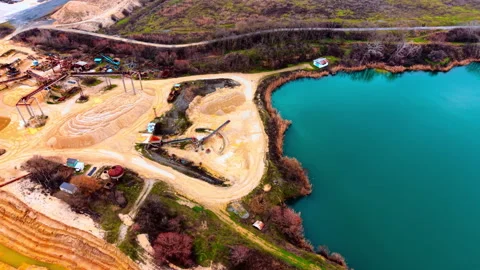 Elevated view of sand processing plant beside turquoise quarry lake, Bulgaria Stock Footage 336725555