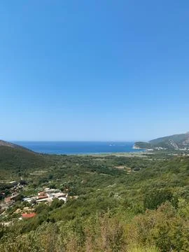 Elevated view shows a green valley stretching to the Adriatic Sea Stock Photos