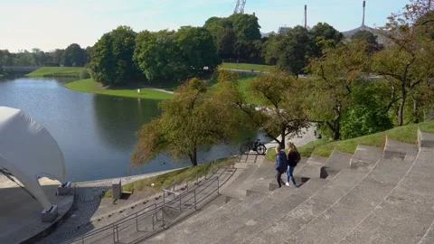 Elevated view of small pond and couple walking on the stairs Stock Footage 170895432
