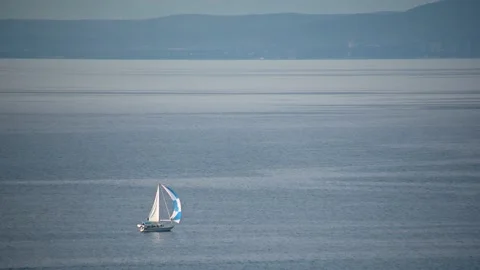 Elevated view of a small sailboat on the open sea Stock Footage 202112176