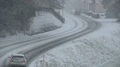 Elevated view of snow falling on countryside road in small town, Slovenia Stock Footage 146332353