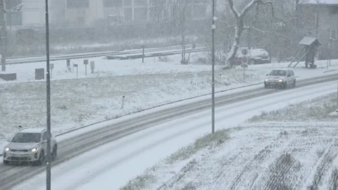 Elevated view of snow falling on countryside road in small town, Slovenia Stock Footage 146360610
