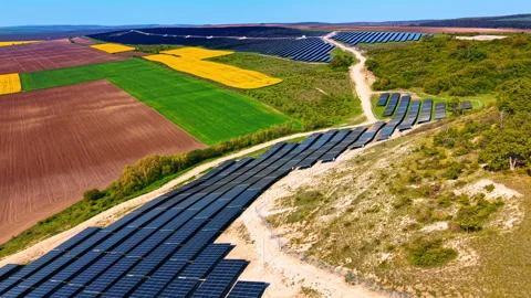 Elevated view of solar farm and colorful agricultural patchwork fields. Dark Stock-Footage 336386677