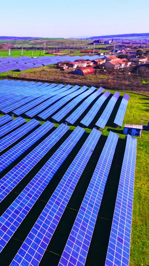 Elevated view of solar farm bordering rural village, Bulgaria Vertical video. Video stock 338008052
