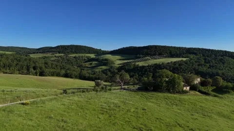Elevated View of Sunlit Meadow Slopes and Distant Forest Ridges Stock Footage 346204843