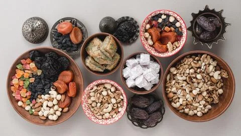 Elevated view traditional sweets dried fruits nuts white background Stock Photos