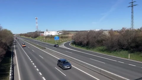 Elevated view of tranquil road with sparse vehicles and distant structures Stock-Footage 347334651