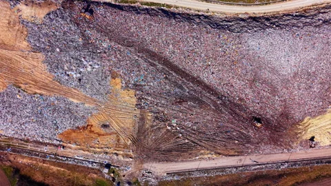 Elevated view of trash mound with heavy machinery, Bulgaria Stock Footage 345150675
