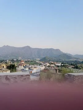 Elevated View of a Valley Town Beneath Majestic Peaks Stock Photos