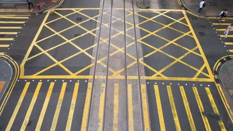 Elevated View of Vehicles at Intersection with Yellow Grid and Zebra Crossings Stock Footage 294507184