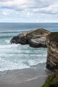 Elevated view of a wild beach with coarse grey sand and rough ocean. Stock Photos