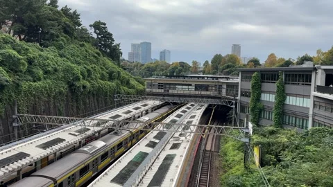 Elevated view of Yotsuya Train in Tokyo, Japan, showing commuter trains on Видео 334950592