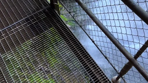 Elevated Walkway Behind Giessbach Waterfall on the Mountain Side and Grandhotel Stock Footage 264576327