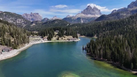 Elevated Wide View of Turquoise Lake Surrounded by Forests and Peaks Stock Footage 341724244