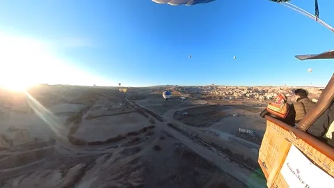 Elevating above the historic terrain of Cappadocia by Balloon. Video stock 265451633