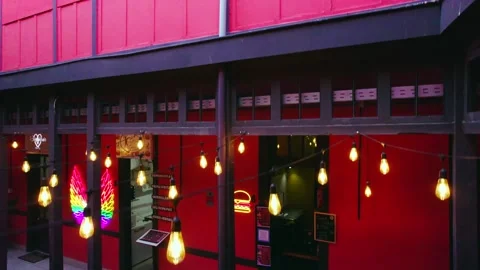 Elevation shot with warm lights hanging and restaurants inside The Garden Video stock 256142254