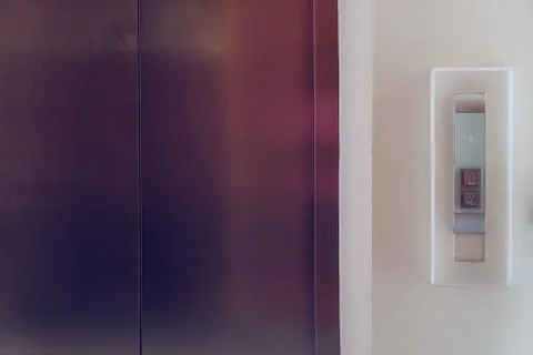 Elevator button up and down, modern metal elevator close door in building off Foto stock