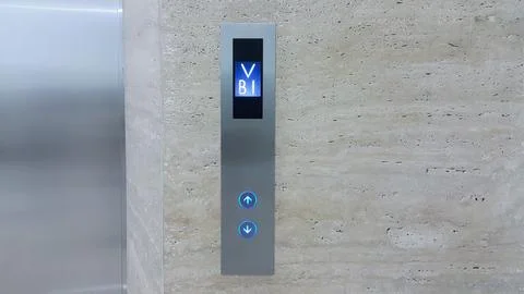 Elevator button up and down with screen indicating the B1 floor Stock Photos