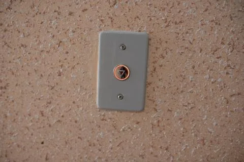 Elevator button close up orange wall Stock Photos