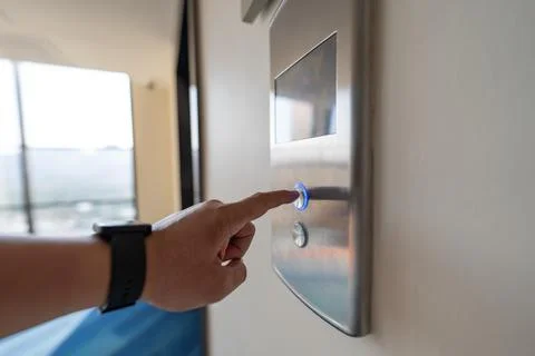 Elevator button, finger pressing up, vertical transportation captures a clo.. Photos