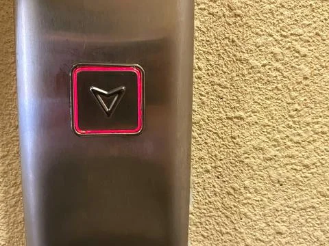 Elevator button panel with a downward arrow symbol Foto stock