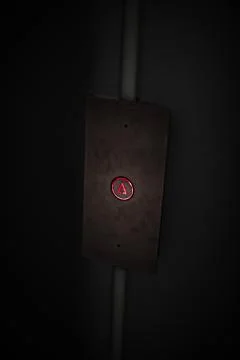 Elevator Button up red on stainless plate concept business dark detail office Foto stock