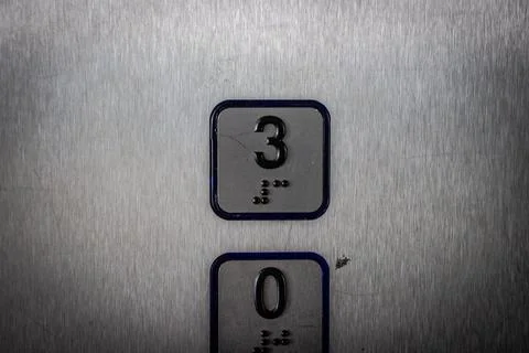 Elevator buttons 0 and 3 with braille on them in Spain Stock Photos