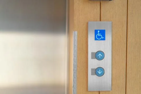 Elevator buttons with Braille codes and handicap sign. Allow signs for up and Stock Photos