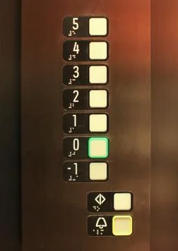 Elevator buttons, number 0 in green, blind, text in Braille alphabet under nu 스톡 사진