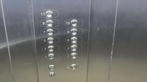 Elevator buttons showing floors with numbers and lights in a building during Stock Footage 328411815
