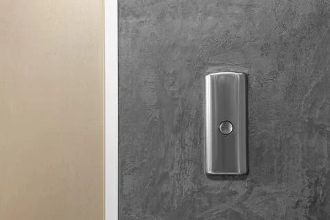 Elevator call button on grey textured wall Foto stock
