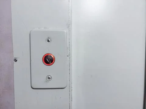 Elevator call button, new button in old house, silver button with red backlight Foto stock