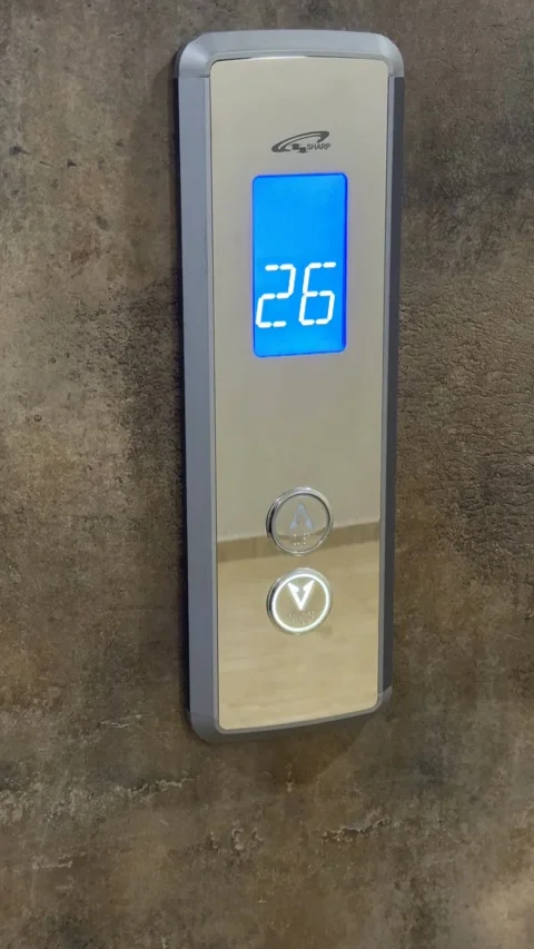 Elevator control panel with blue display showing number 26 against textured.. Stock Footage 336398536