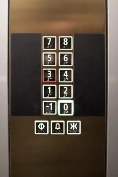 Elevator control panel displaying floor numbers and buttons in a modern building 스톡 사진