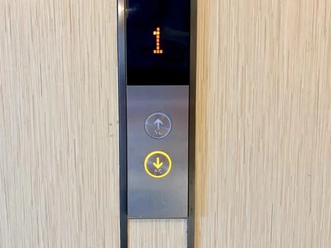 Elevator Control Panel with Floor Indicator and Lit Down Button Fotos de archivo