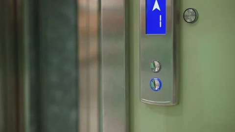 Elevator control panel with illuminated blue arrow indicating upward direction Stock Footage 316649687