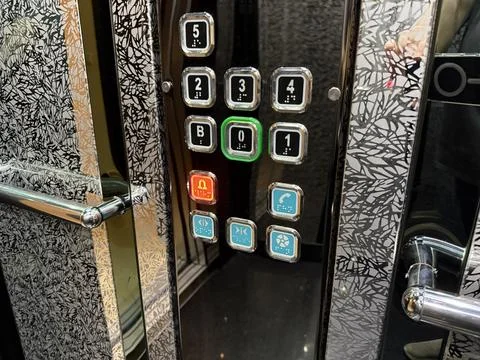 Elevator control panel with illuminated buttons in modern interior design Stock Photos