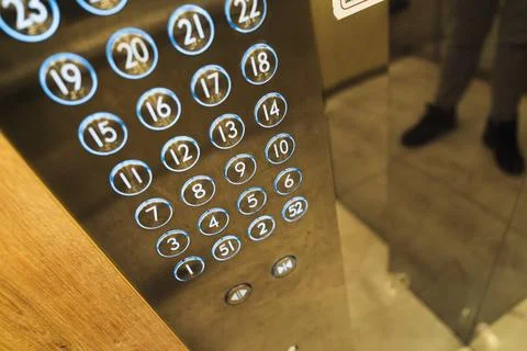Elevator control panel with illuminated floor buttons Stock Photos