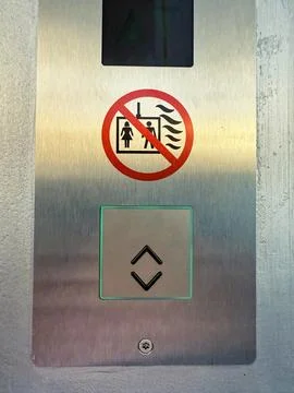 Elevator control panel with no smoking or ventilation warning sign on metal.. Stock Photos