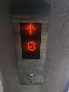Elevator digital display showing upward arrow and floor number Stock Photos